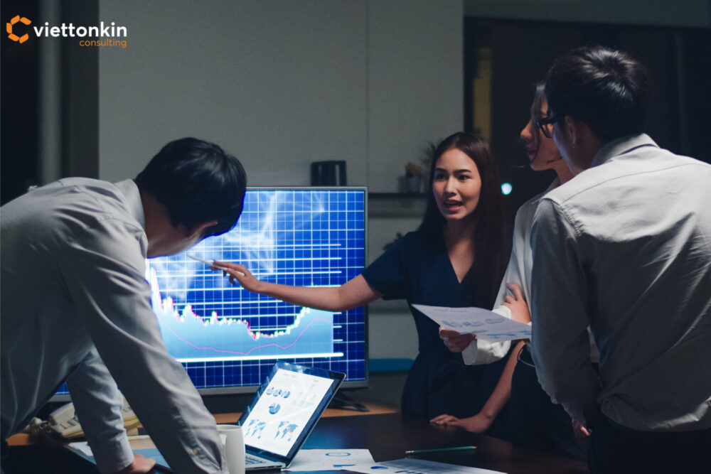 Business team brainstorming and analyzing market data on screen, symbolizing strategic planning and success roadmap for Vietnam’s pharmaceutical drug business