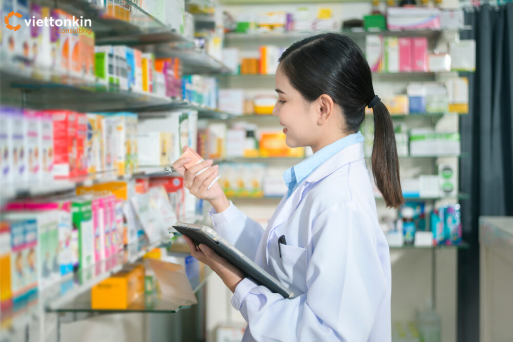Female pharmacist checking medicine products in a modern pharmacy, representing pharmaceutical drug business operations and healthcare service