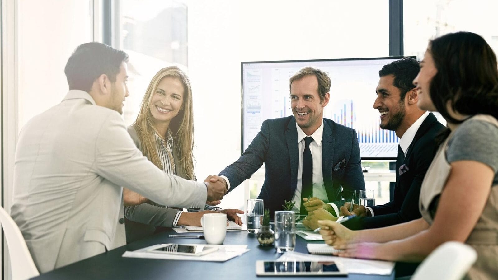 Business handshake acquisition meeting in Vietnamese manufacturing